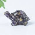 Carved amethyst turtle ornament with gold leaf inclusions on a white background - 15 Amethyst + Gold Foil