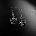 Gothic silver earrings featuring detailed butterfly and skull wings on a dark backdrop - Skull Butterfly
