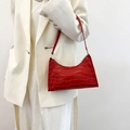 Red crocodile pattern leather baguette bag styled with a white blazer for women - Red
