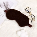 Deep brown plush teddy fleece sleep mask with elastic silk strap on soft background - Coffee