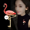 Pink flamingo brooch with white pearl and gold accents on a black background - Flamingo Style A