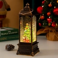 Farol navideño vintage de bronce con Papá Noel, efecto nieve y luz LED cálida - Árbol de Navidad Estacionario