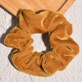 Close-up of ginger yellow velvet scrunchie showing soft pleated fabric texture and sheen - Mud Yellow