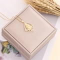 Virgin Mary zircon pendant on gold box chain displayed on a beige jewelry box - Large Oval Virgin Mary Style (10#)