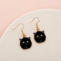 Spooky black Halloween monster earrings with blue horns and gold-tone hooks - Black Unicorn Monster
