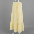 Detail of light yellow tiered maxi skirt featuring textured fabric and adjustable drawstring - S / Standard Type / Yellow