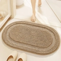 Absorbent light brown oval bath mat with soft plush texture in a cozy bathroom setting - Khaki (Jianxin Series)