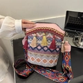 Bohemian drawstring bucket bag with colorful tassels and wide woven shoulder strap - Pink