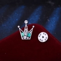Silver crown lapel pin with green crystals and rhinestones on red velvet surface - Green Rhinestone (Silver Base)