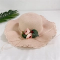 Detail of pink straw sun hat with wavy edges and decorative faux rose floral accents - Adult M / Light Pink
