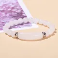 Handmade natural white jade beaded bracelet with silver metal spacers on a warm beige background - Natural White Jade