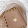 Macro shot of gold heart necklace with white pearl texture and pavé crystals on silk - Heart Mother of Pearl Necklace (C249)