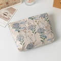 Close-up of beige embroidered cosmetic bag with blue hydrangeas and silk texture - Blue Hydrangea Jacquard (Large)