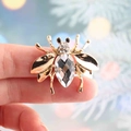 Exquisite gold bee brooch featuring a large teardrop crystal and sparkling rhinestones - White
