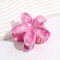 Detail of pink marble gradient flower hair claw on a white wavy stone display base - Gradient Rose Red