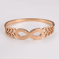 Detailed macro of rose gold infinity bracelet with matte finish and hollow patterns - Rose Gold