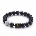 Detail of 10mm black onyx and white turquoise bead bracelet with gold D letter bead - Letter D