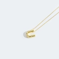 Elegant gold necklace featuring a horseshoe pendant set with six white pearls on fine link chain - Letter U