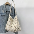Detail of corduroy tote bag with yellow tulip print hanging on denim jacket - Orange Tulip