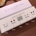 Detail view of five pairs of heart and crystal stud earrings on a weekday display card - Red Blue Pink Zirconia Set (NS911-22) / 5 Pairs/Pack / Red and Blue