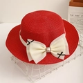 Close-up of red straw hat featuring a large cream tulle bow and pearl centerpiece - Red