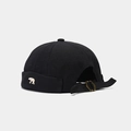 Detail of bear embroidery and metal buckle strap on a black canvas brimless miki hat - Adjustable / Black