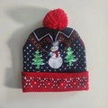 Detail view of the ON/OFF switch on the LED Christmas knitted hat with snowman patterns - Double Christmas Trees Snowman