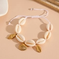 Detail of adjustable beach shell bracelet with golden starfish and conch shell charms - White Rope Shell Bracelet
