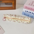 Detailed macro of floral pencil case fabric with elastic pleats and pink zip puller - Floral Red