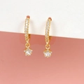 Chic gold star hoop earrings with sparkling crystal pavé on pink and white background - Pavé Zirconia Star Hoop Earrings