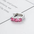 Silver huggie hoop earring featuring three sparkling pink zircon stones on a white background - Rose Red (Single Piece)