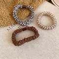 Set of 3 elastic hair ties featuring brown woven fabric and animal print spiral designs - Deep Coffee and White Set of Pieces