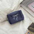 Detail view of navy blue canvas cosmetic bag with bow embroidery and silver zipper - Gray