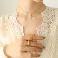 Golden butterfly jewelry set with tassel necklace and two elegant rings on model - Gold