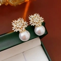 Macro shot of gold plated snowflake pearl earrings on a dark green jewelry gift box - 58# Gold Radiative Starburst Pearl Style (HE30401)