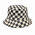 Detailed view of black and white checkerboard pattern with smile prints on a bucket hat - M (56-58cm) / Beige