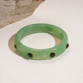 Detail of green acrylic bangle with faceted emerald crystals in golden settings - Light Green