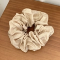 Champagne gold metallic scrunchie in pleated satin fabric on wooden surface - Large / Khaki