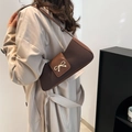 Chic two-tone brown baguette bag with metal bow detail for women in 2025 fashion style - Brown