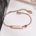 Macro shot of rose gold stainless steel bracelet with engravable bar and red enamel heart - Rose Gold