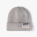 Light grey ribbed knit beanie for winter featuring a trendy boarding pass style patch - One Size / Light Gray