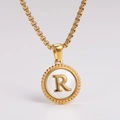 Macro view of gold-plated necklace featuring a white shell pendant with a 3D R letter - Letter R