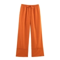 Close-up of orange linen wide-leg pants with drawstring waist and wide folded hem detail - Orange Pants