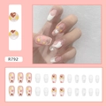 Detail view of pink and white heart press-on nails with French tips and 24-piece set - Hollow Heart Style (R792)