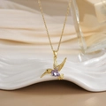 Macro shot of hummingbird pendant with purple teardrop gem and sparkling crystals - FN0123 Purple Teardrop Zircon Hummingbird