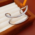 Macro shot of silver irregular double-layer open bangle with a polished wavy metallic finish - Silver