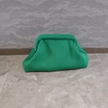 Detailed close-up of vibrant green knitted cloud clutch bag with woven mesh texture - Green