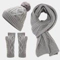Flat lay of gray cable knit winter set including pompom hat scarf and fingerless gloves - Gray