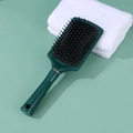 Dark green anti-static hair cushion brush with massage bristles on light green background - Green Large Square