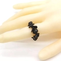 Elastic ring featuring natural irregular black crystal stone chips on model hand - Obsidian